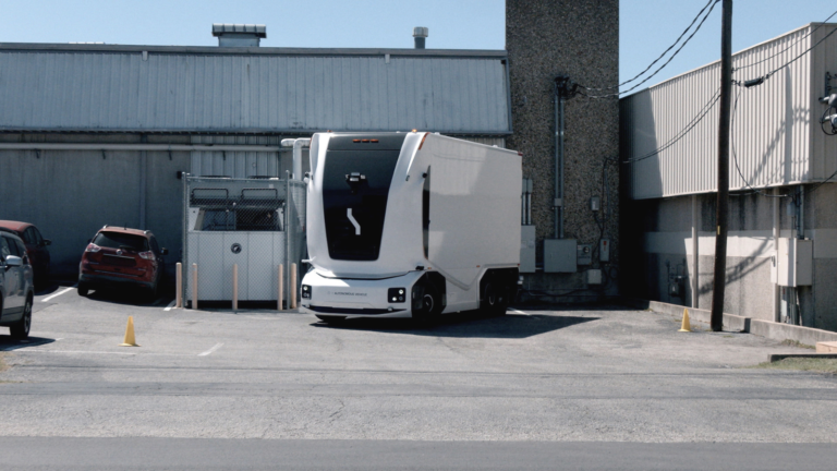 An electric heavy transport vehicle utilizing autonomous freight solutions along a commercial shipping corridor.